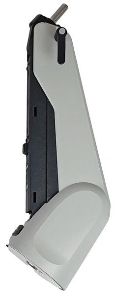 The image shows a gray, slanted object with a smooth surface and a black part. It has a handle and appears to be a device or tool.