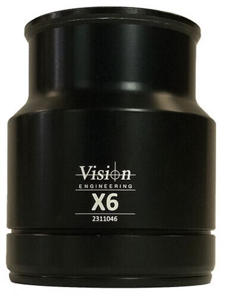 The image shows a black cylindrical attachment with a wide top opening. On the front, there is the inscription "Vision Engineering X6" and a number. The surface is shiny and smooth.