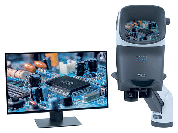 The image shows a microscope next to a monitor. On the monitor, there is a close-up of a circuit board with a microchip and various electronic components.