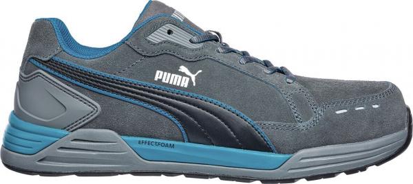 The shoe is a gray athletic shoe with blue accents. It has a smooth, durable surface and a wide, cushioned sole for comfort. The logo is white and clearly visible.