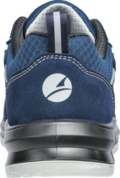 The image shows the rear view of a blue sports shoe. It has a sturdy, black sole area and a gray inner padding. A distinctive logo is visible on the heel.