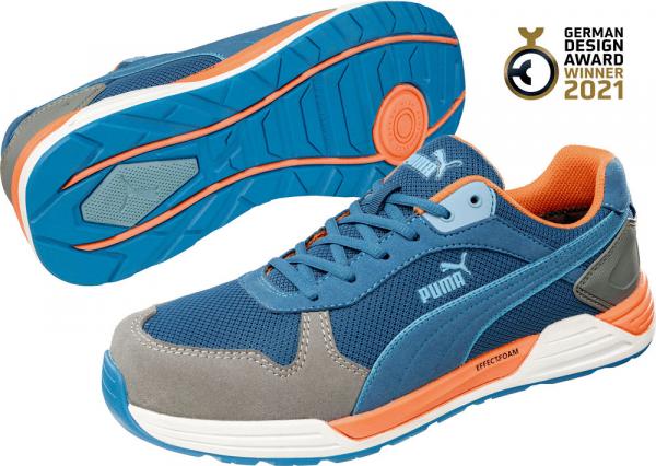 The image displays an athletic shoe by Puma. It features a blue upper with gray and orange accents. The sole is grippy and exhibits a modern design.