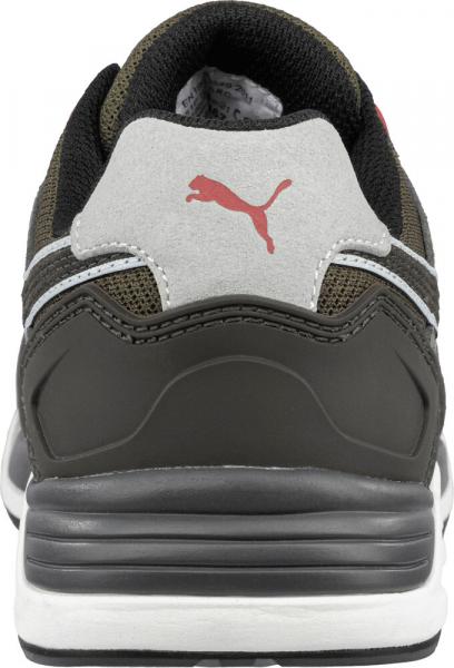 The image shows the rear view of a sports shoe. It is designed in a dark color with gray and white details. There is a red Puma logo on the heel.