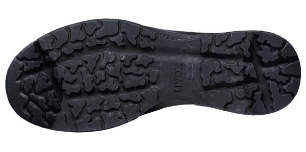 The image shows the underside of a shoe. The sole is black, with a coarse tread featuring deep grooves and patterns that provide good grip on various surfaces.