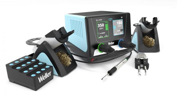 The image shows a soldering station with a casing in blue and black. It features two digital displays, a soldering tip, holders for solder wire and cleaning, and a tool stand with multiple soldering irons.