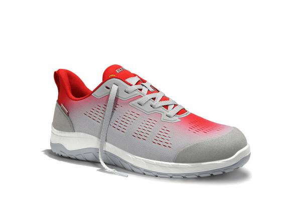 The shoe is sporty, primarily gray with red accents. It has a flat, non-slip sole and a breathable upper structure. The laces are visible.