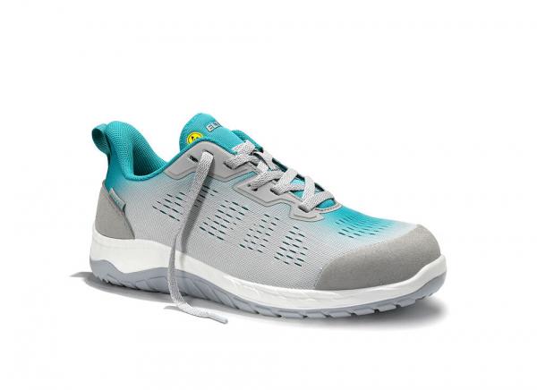 The shoe is a sporty sneaker in gray and turquoise. It has a breathable surface with side holes and a flexible rubber sole. The laces are loosely tied.