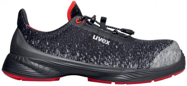 The shoe is sporty, predominantly black with gray and red accents. It has a soft, breathable upper and a flexible, non-slip sole. Quick lacing system included.