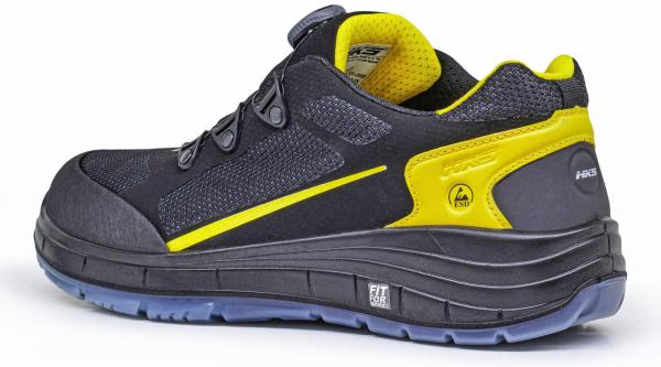 The shoe is black with yellow accents. It has a sporty shape, a thick, textured sole, and a padded insole. The laces are tight and secure.