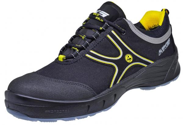 The shoe is a sporty sneaker in black with yellow and gray accents. It features a lightweight, functional design and a sturdy rubber sole for good grip.