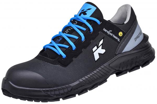 The shoe is black with blue laces. It has a reinforced toe and a grippy sole. The side features a logo in white and a gray heel cap. Ideal for work or leisure.