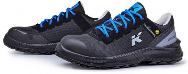 The image shows a pair of black safety shoes with blue laces. They feature a sturdy, non-slip sole and are partially made of breathable material.