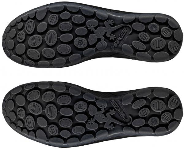 The image displays the sole of two shoes. They are black with numerous small round bumps and an embossed gecko motif in the center. The sole has a flexible and slip-resistant appearance.