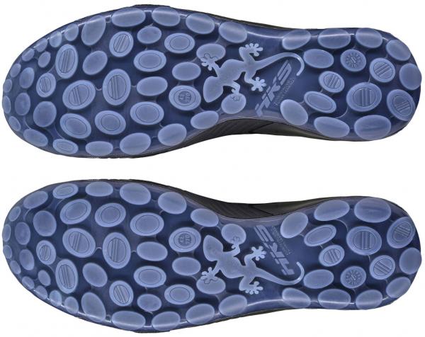 The image shows the underside of a shoe with a flexible, textured sole. The sole features many small, oval knobs and two stylized lizard motifs. It appears to be slip-resistant.