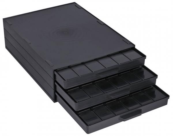 The image shows a black, flat storage box with four drawers. The drawers vary in depth and have numerous small compartments for organization.