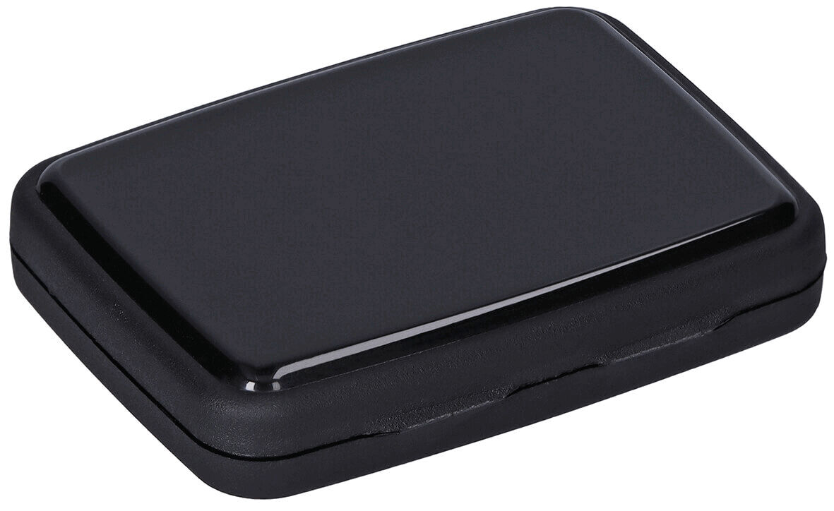 The image shows a rectangular, flat box in matte black. It has rounded corners and appears to be made of plastic. The surface is smooth and shiny.