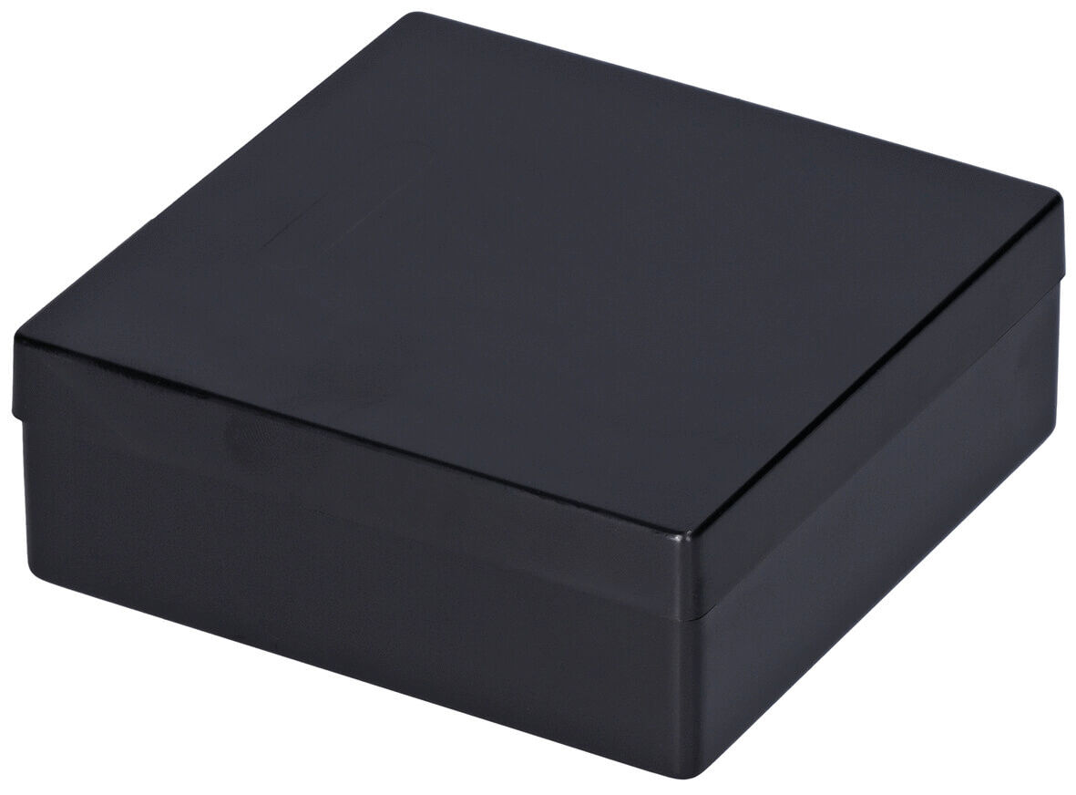 The image shows a square, black box. It has a flat lid and a smooth surface that appears shiny. The edges are right-angled and the box stands stable.