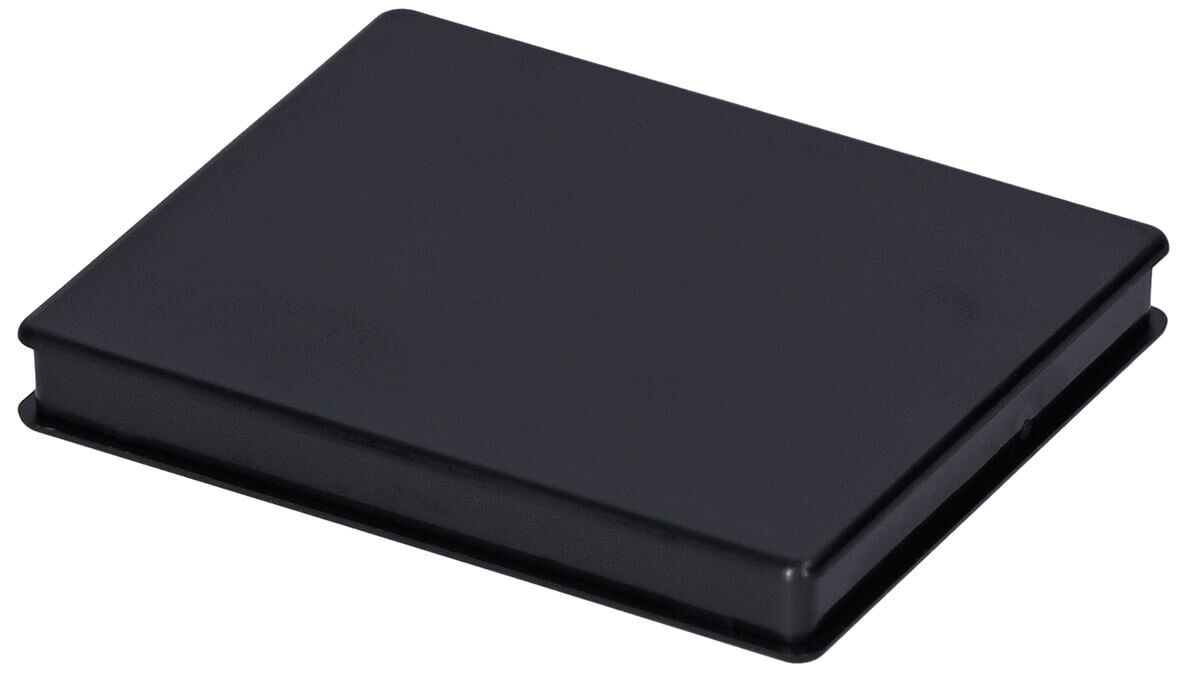 It is a rectangular, flat object in black. The surface is smooth and even, with rounded corners. It looks like a compact container or a pouch.