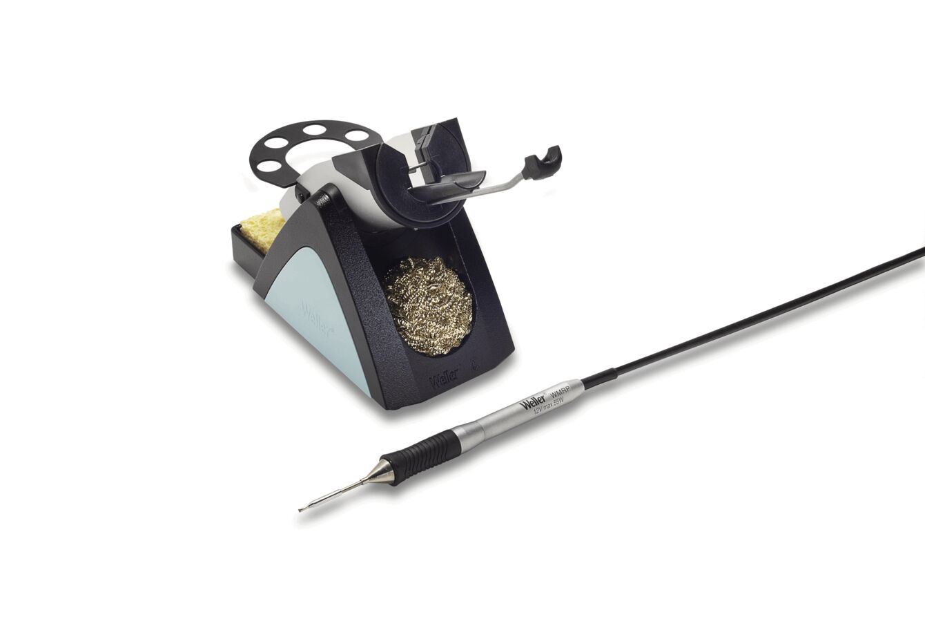 The image shows a soldering station. It consists of a stable base with a holder for a soldering iron, a sponge for cleaning, and a container with solder. A cable connects the iron.