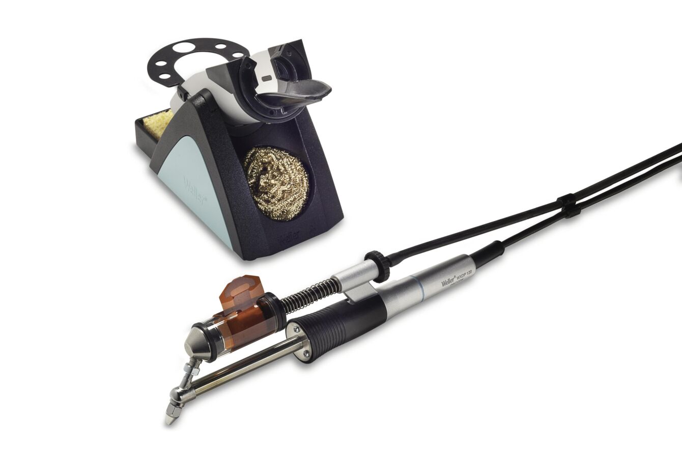 The image displays a tattoo machine with a metal grip and a cable connected to a colored base. The base features a round cutout and a dark color.