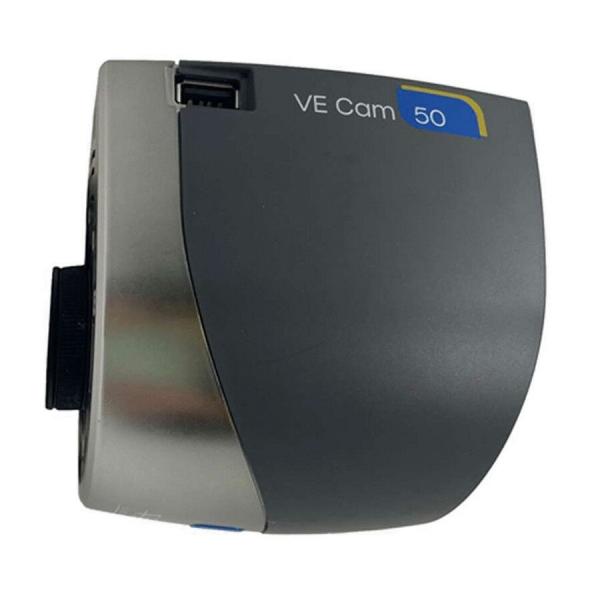 The image shows a compact, gray camera with a rounded body and a silver front. It has a short lens opening and is labeled "VE Cam 50".