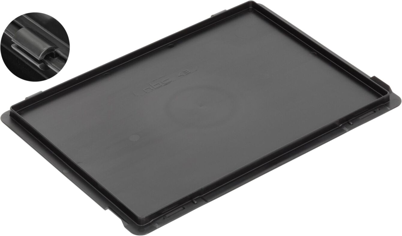 The image displays a black, rectangular plastic casing. It has smooth surfaces and small recesses or brackets at the corners. A small section reveals a detailed area, likely a fastener.