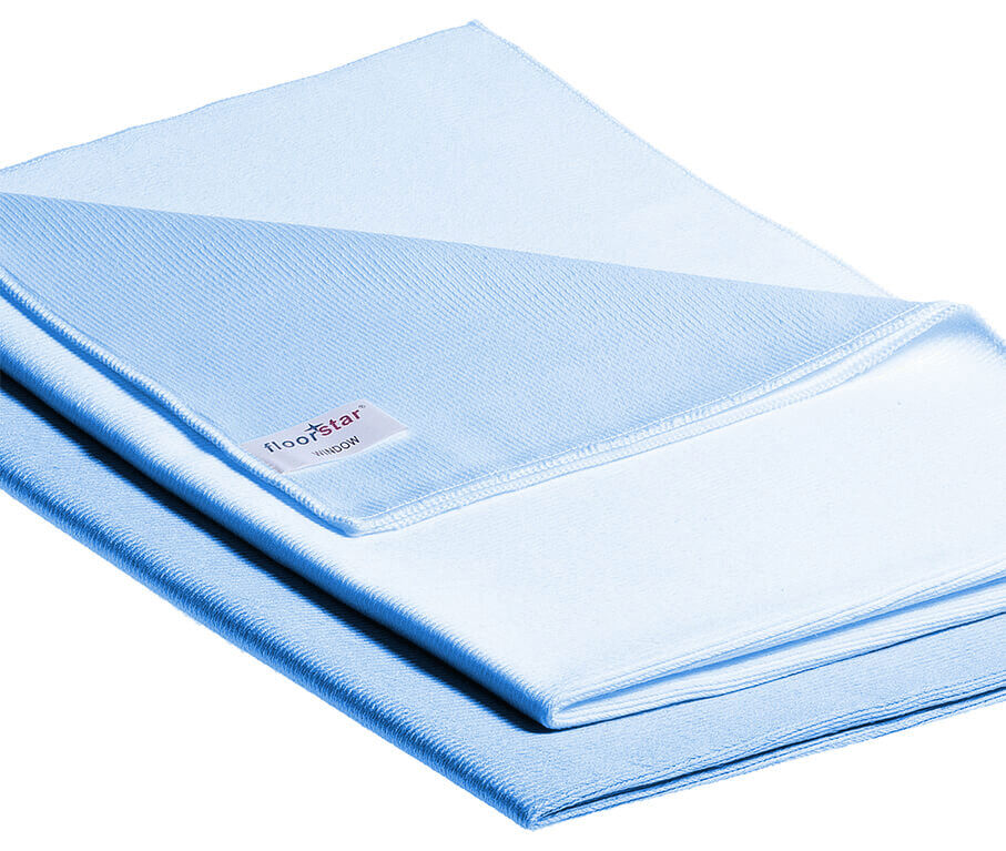 The image shows a light blue cloth, smooth and wrinkly. It is folded and has a labeled corner. The texture appears soft and light.