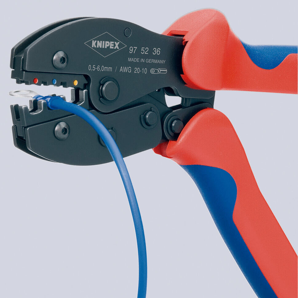 The image shows a cable crimping tool with red-blue handles. The tool has a closed, black working opening into which a blue cable bundle is inserted.