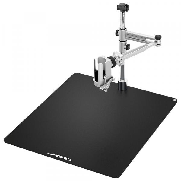 The image shows a black work surface with a metal bracket. The bracket is adjustable and has a clamp to secure objects.