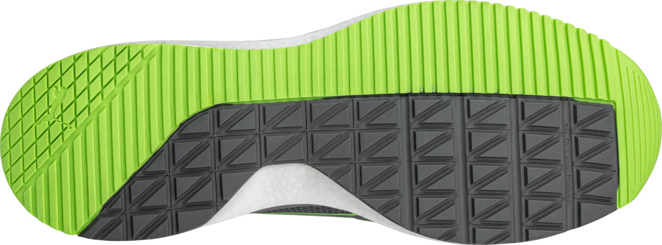 The image shows the sole of a sports shoe. The sole has a black area with a textured surface and a green area with grooved patterns.