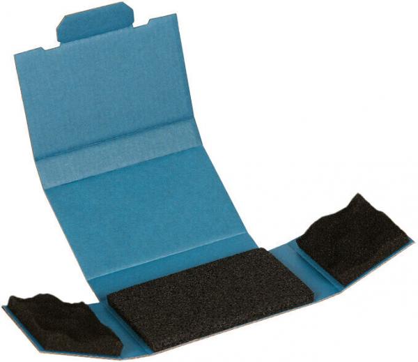 The image shows an opened, blue package. In the center, there is a flat, black foam piece, while the side areas also contain black foam pieces.