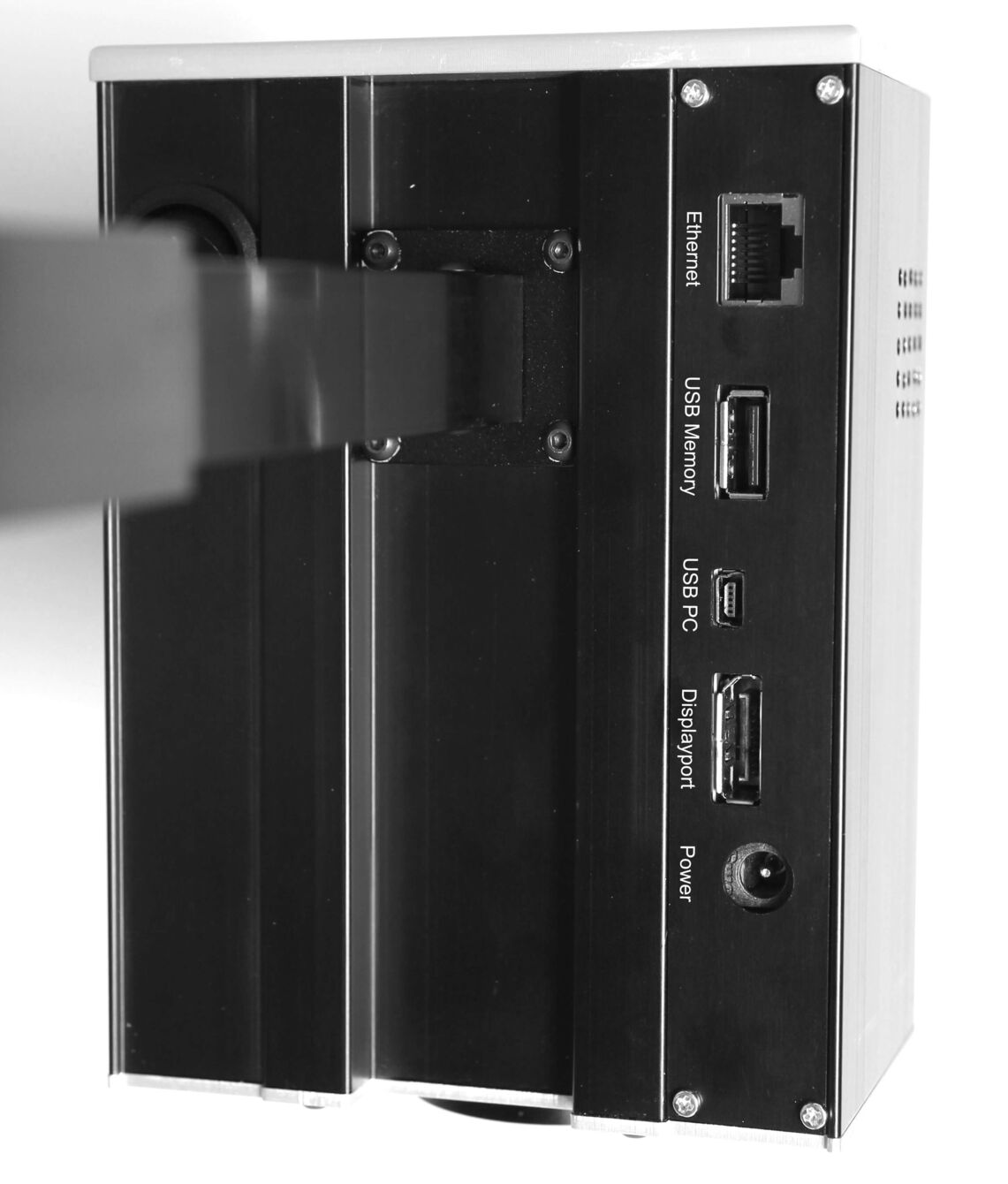 The image shows the back of a device with several connection ports: Ethernet, USB (for storage and PC), DisplayPort, and power supply. The surface is black and metallic.