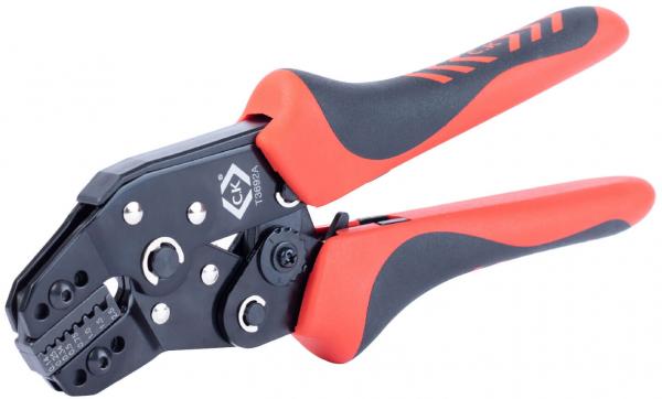 The image shows a pair of pliers with black and red handles. It has a closed front with several openings used for crimping cables. The handles are ergonomically shaped.