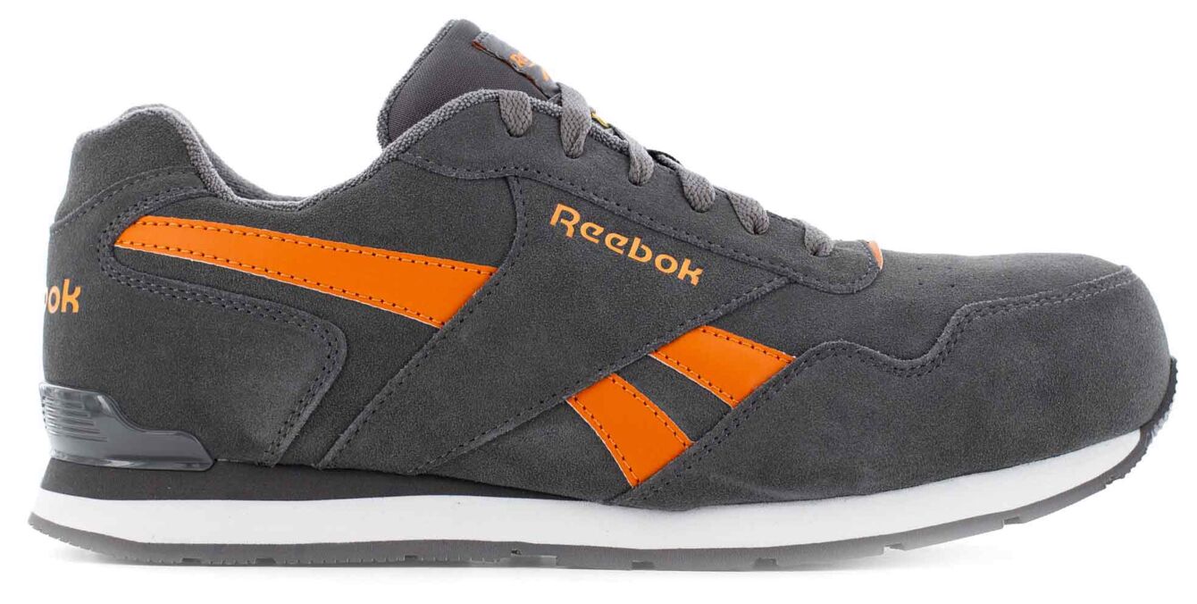 The shoe is a gray sneaker made from soft material with orange details. It has a sporty shape, laces, and a white sole that provides stability.