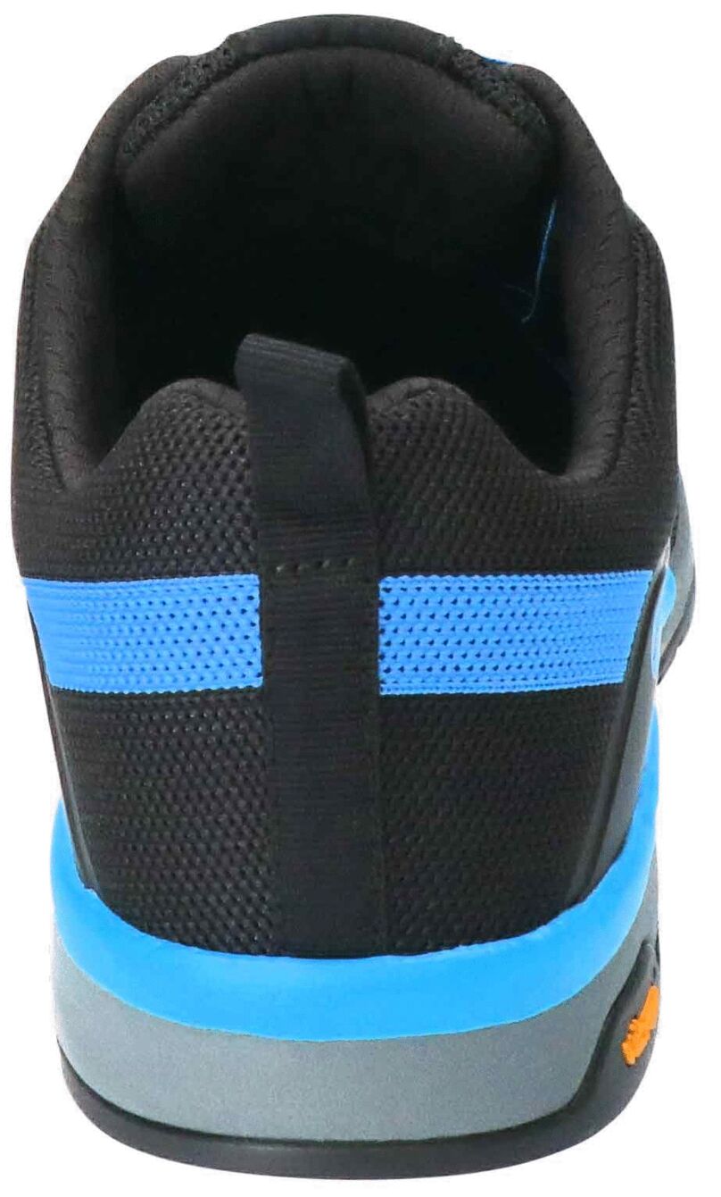 The image shows the rear view of a sports shoe. The shoe is predominantly black with a blue stripe and has a gray sole. A small handle is integrated at the heel.