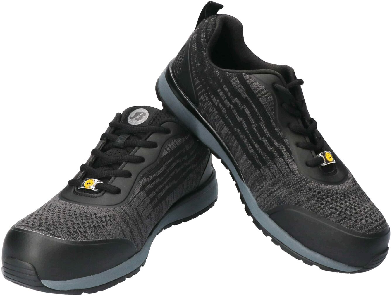 The image shows a pair of sporty black-gray sneakers. They have a textile surface with a textured pattern and a gray rubber sole. The laces are black.