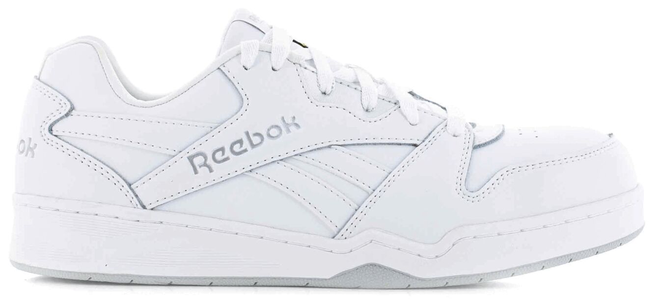 The image shows a white Reebok sports shoe. It has a classic shape with laces and subtle side lines. The sole is sturdy and slightly elevated.