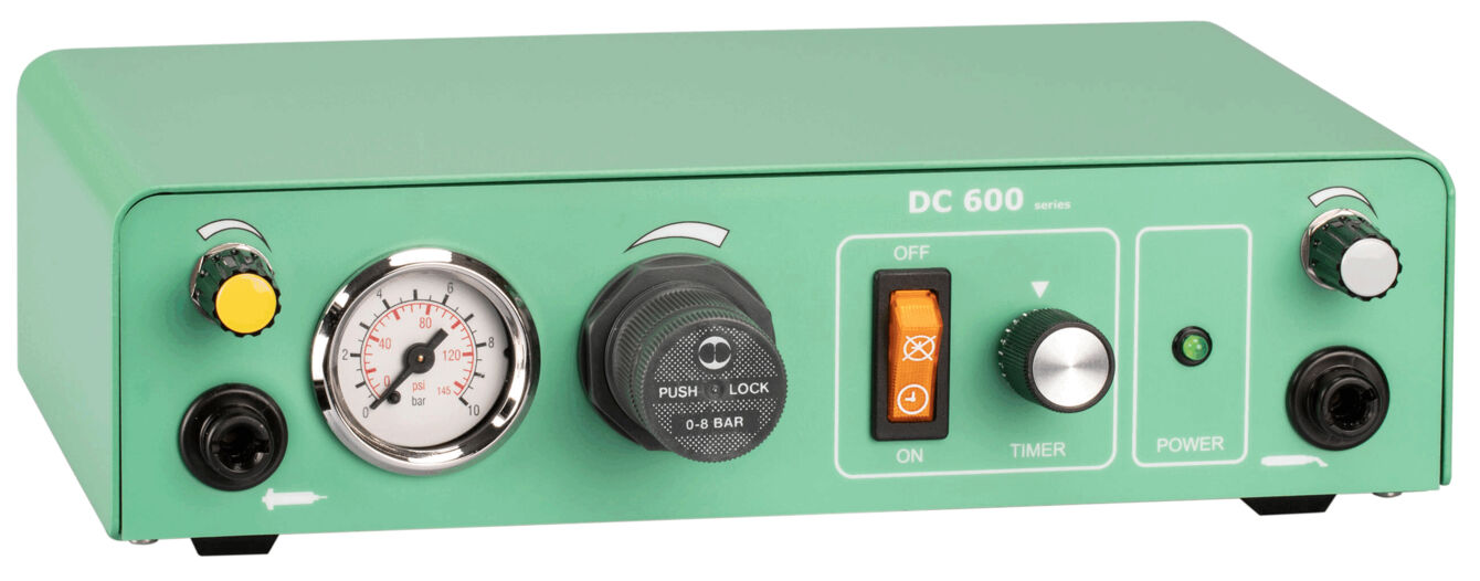 The image shows a green device with a round gauge, several buttons and switches, as well as a timer. The surface is smooth, and there is a power indicator on the front.