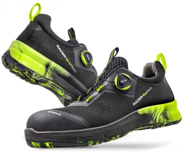 The image shows a pair of black sports shoes with bright green accents. They have a flat sole, are equipped with a Boa closure system, and feature a reinforced toe cap.