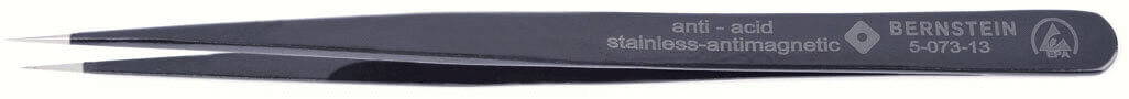 The image shows a dark, pointed tweezer made of stainless steel. It has a matte finish and is marked with the inscription "anti-acid stainless-antimagnetic".