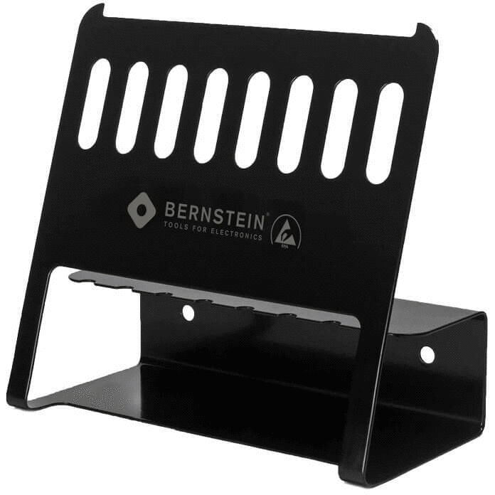 This is a black, metal holder with vertical slots. It has a stable base and is used for storing devices or tools. The slots on top allow for air circulation.