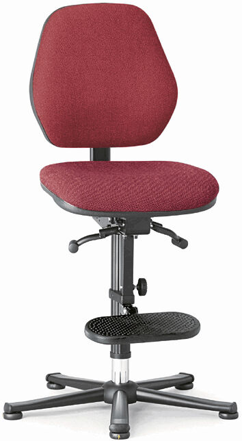 The chair has a red padded seat and a high backrest. It stands on a sturdy base with five casters. There is a footrest under the seat.