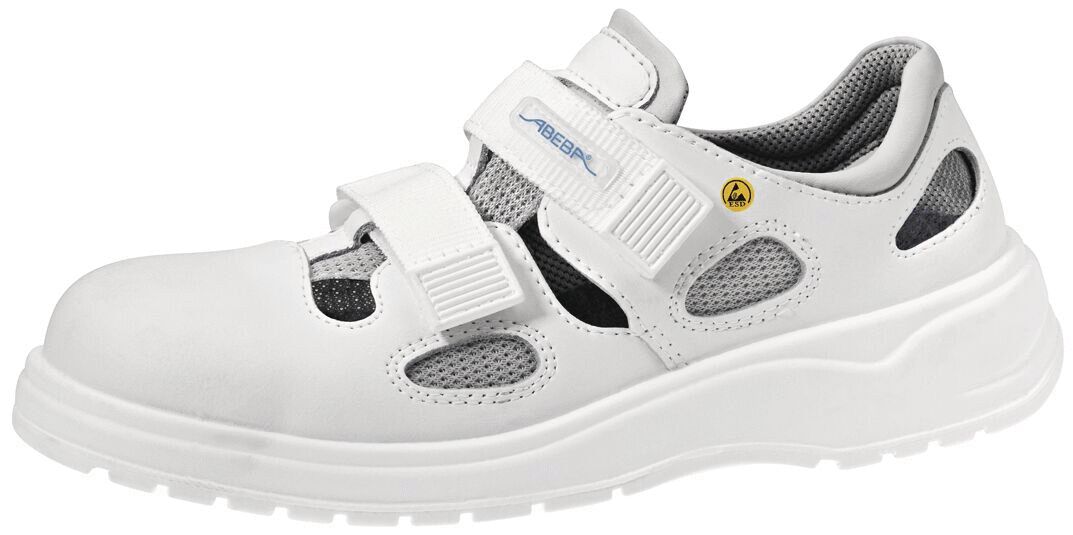 The image shows a white, sporty shoe with two Velcro straps. It features a breezy design with mesh parts and a sturdy, non-slip sole. Ideal for comfort and stability.