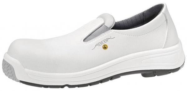 The shoe is a white, non-slip work shoe with a smooth, slightly glossy surface. It has no lace closure and a thick, grippy sole. The shape is comfortable and protective.