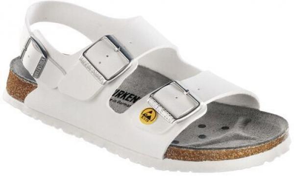 The image shows a white sandal with two wide, adjustable straps and a cork sole. The insole is gray with small holes for ventilation. It has a flat, comfortable shape.