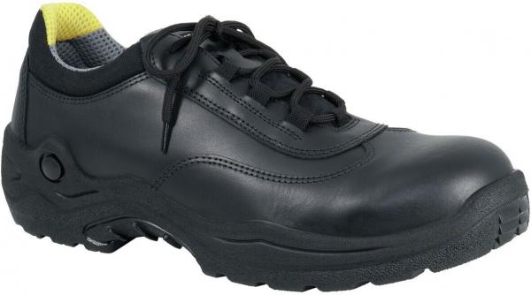 The image shows a black leather safety shoe with a flat sole. It has lacing and a yellow accent color on the back. The sole is sturdy and slip-resistant.